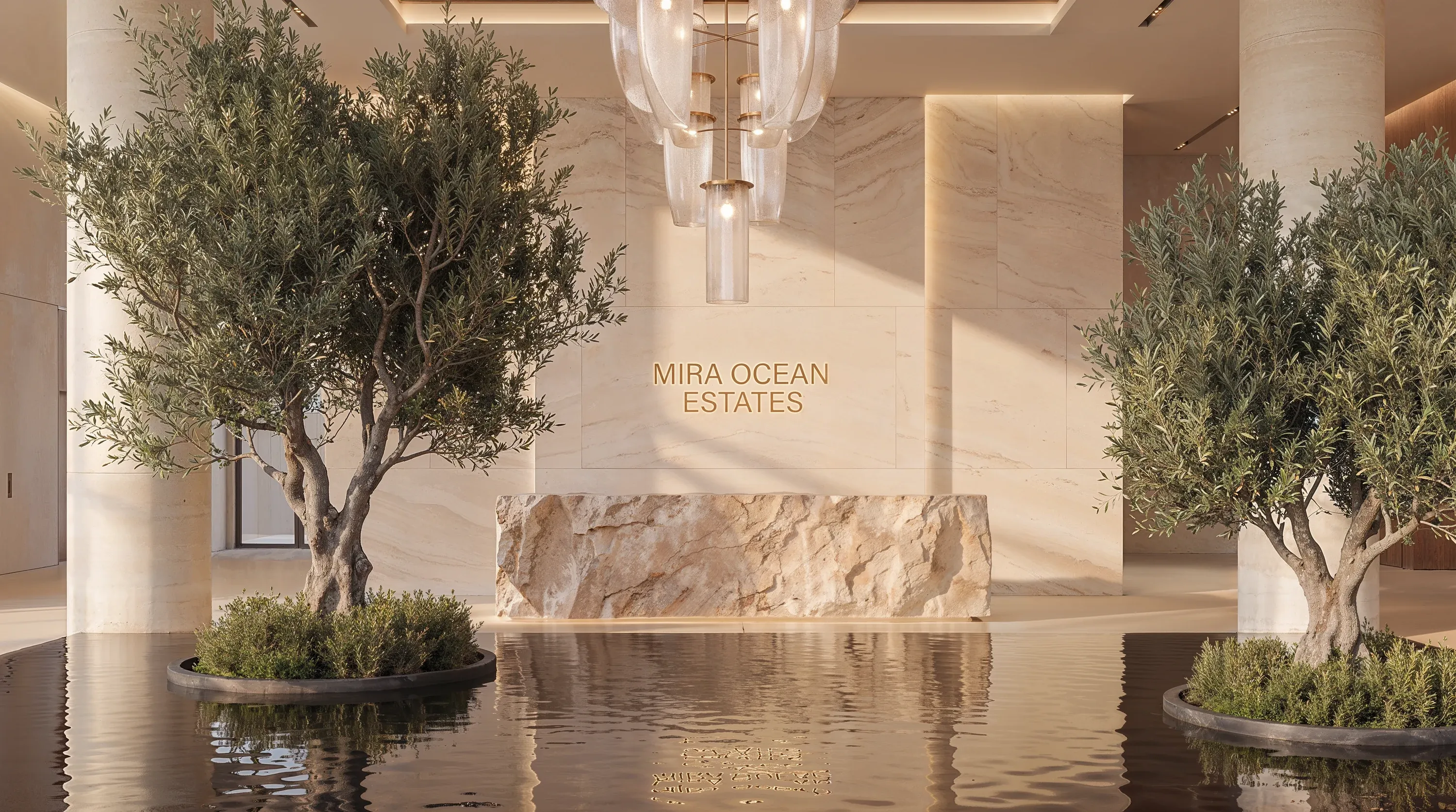 The reception desk of the Mira Ocean Estates lobby, flanked by olive trees