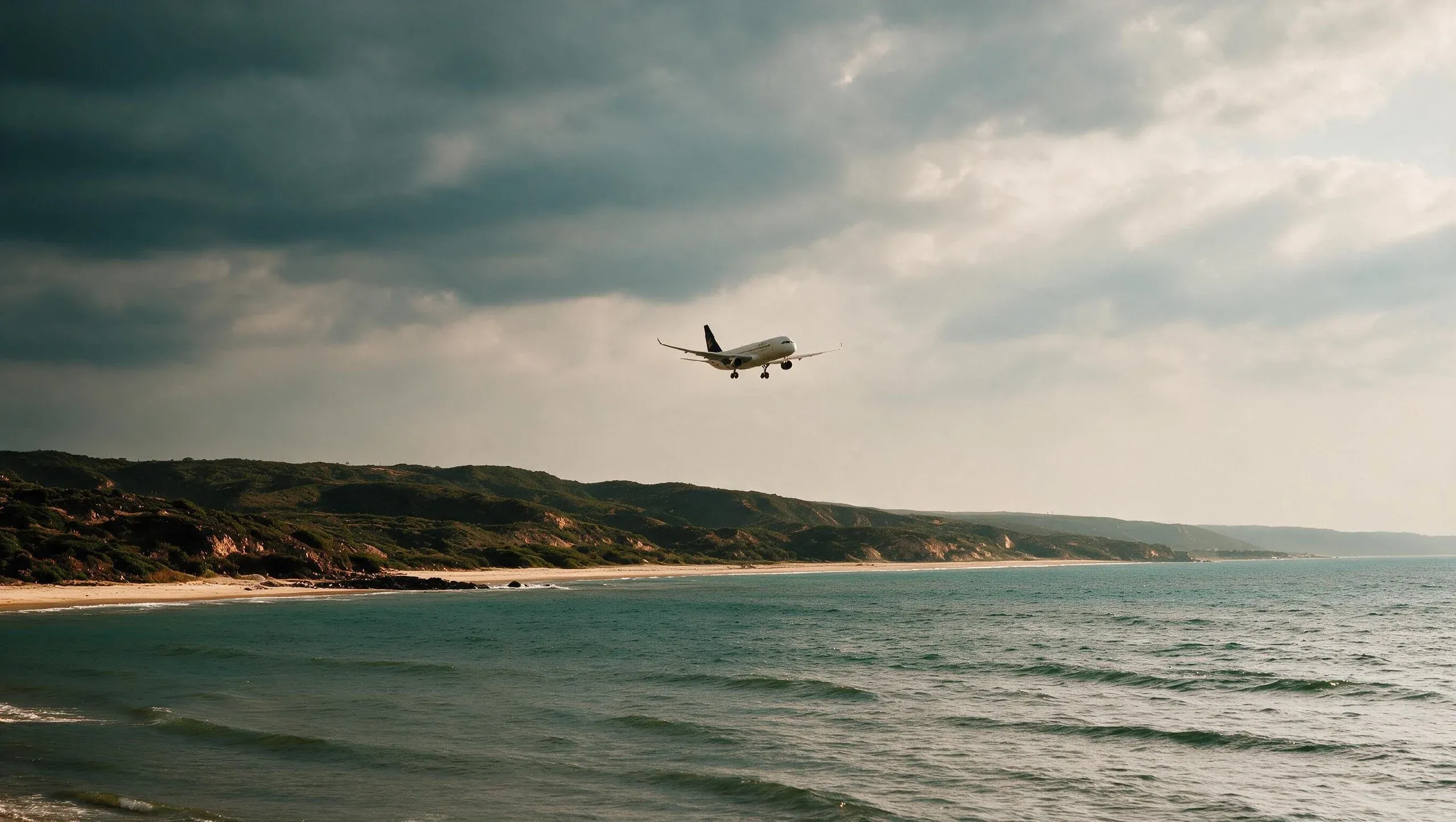 An aircraft on approach over the Salalah coastline